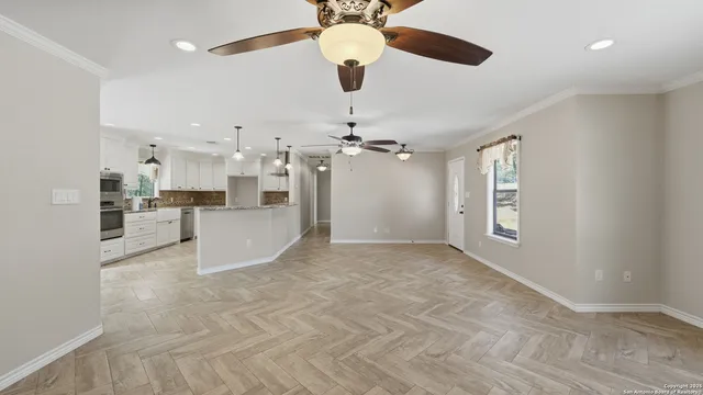 a view of a kitchen with cabinet and a chandelier fan