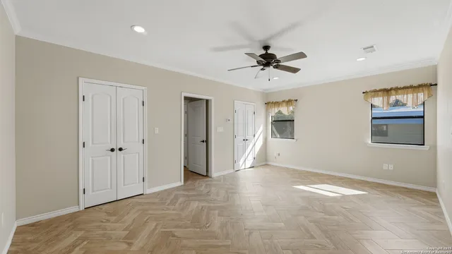 a view of an empty room with a ceiling fan