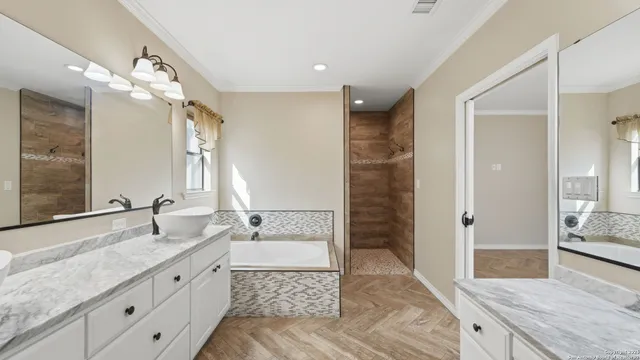 a spacious bathroom with a granite countertop sink mirror and shower
