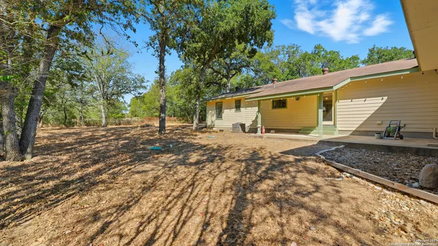 a backyard of a house with large trees