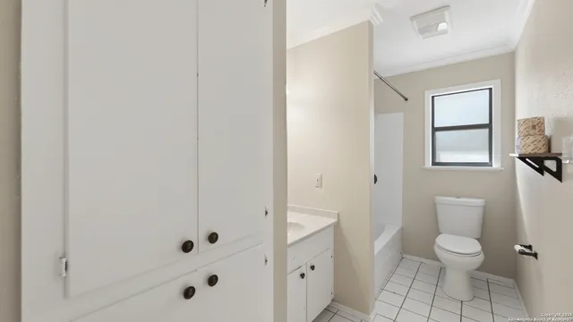 a bathroom with a toilet a sink a shower and a mirror
