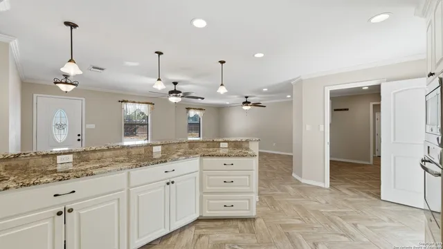 a bathroom with a granite countertop sink a large mirror and a shower