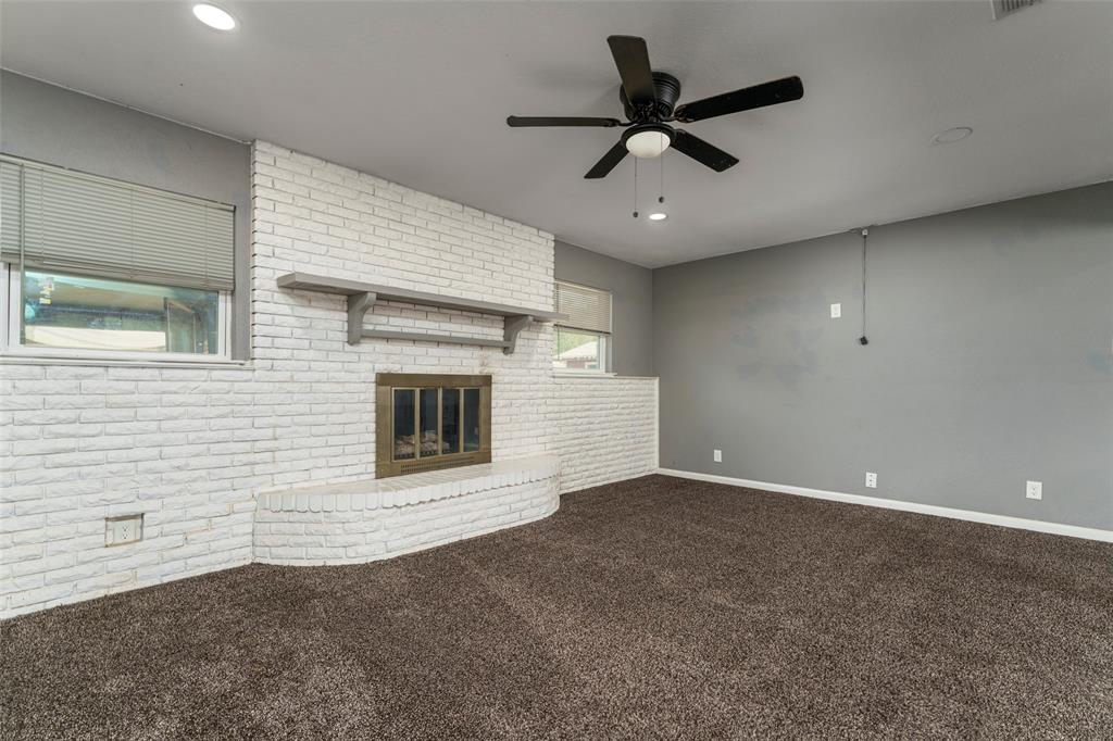 1101 Kennedale Sublett Road Kennedale, TX 76060 - Photo 10 of 35 White painted brick fireplace with hearth, wood mantel, and a built-in firebox
