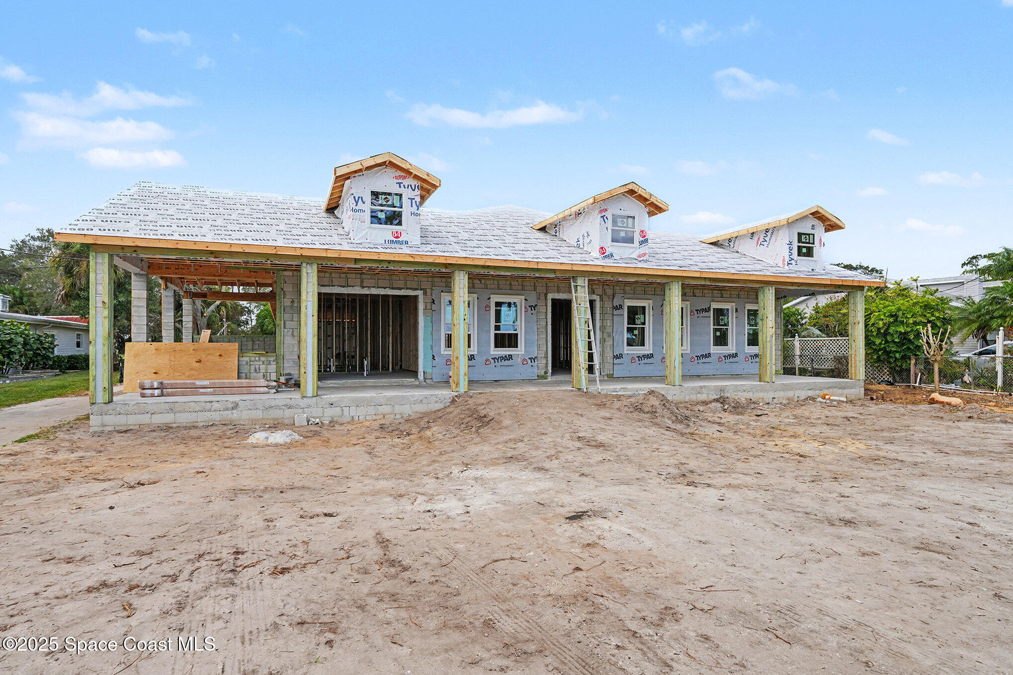 1863 Rockledge Drive Rockledge, FL 32955 - Photo 13 of 43 a view of a white house with large windows and a small yard