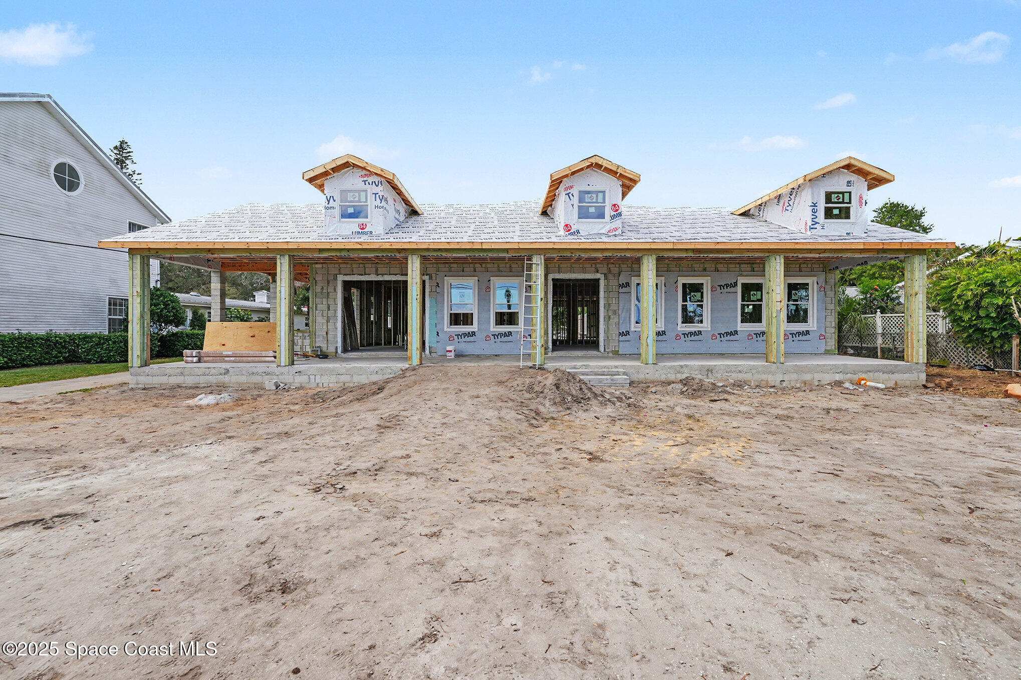 1863 Rockledge Drive Rockledge, FL 32955 - Photo 14 of 57 a view of a white house with large windows and a small yard