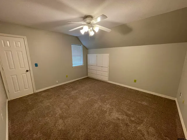 a bathroom with a granite countertop sink and shower