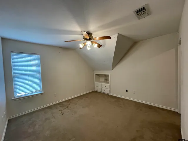 a bathroom with a granite countertop toilet a sink a mirror and shower