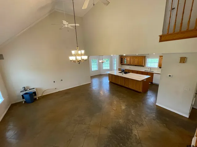 a view of a livingroom with a ceiling fan and window