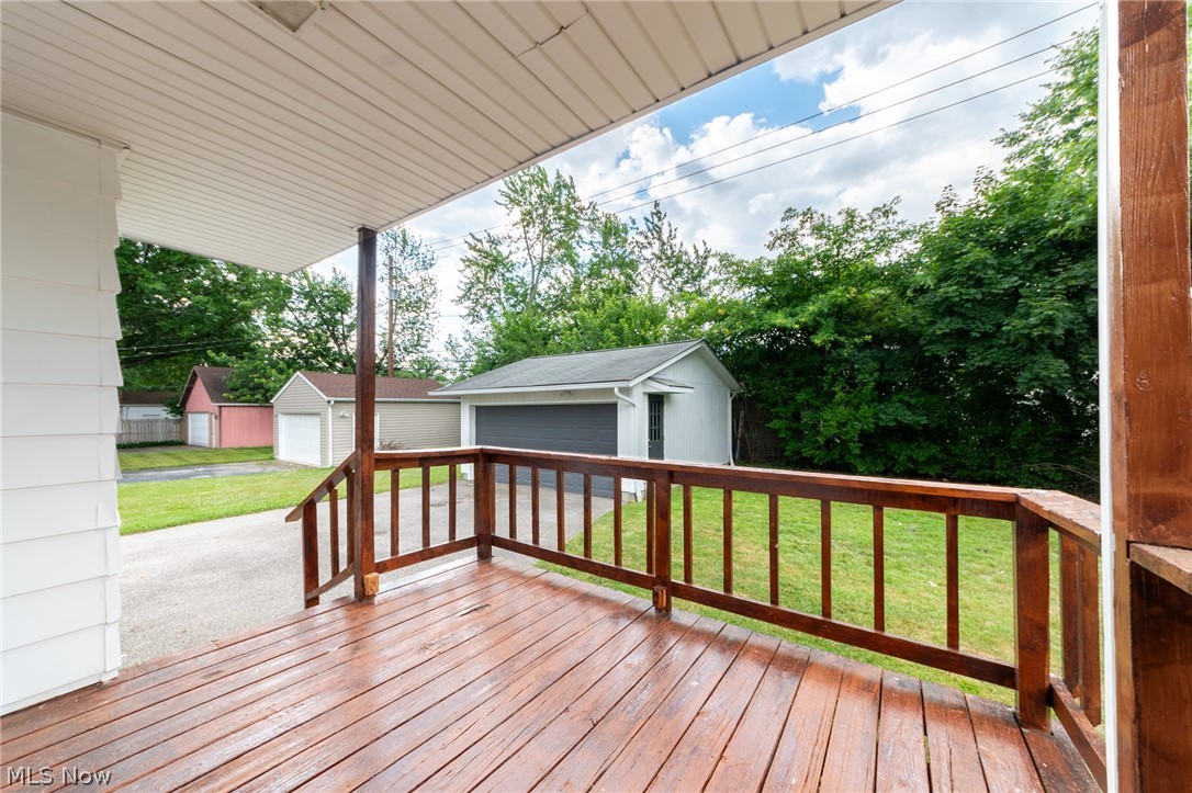 4122 Lambert Road Cleveland, OH 44121 - Photo 32 of 32 Wooden terrace featuring an outdoor structure, a lawn, and a garage