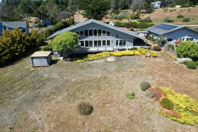 a kitchen with kitchen island granite countertop a sink stainless steel appliances and cabinets