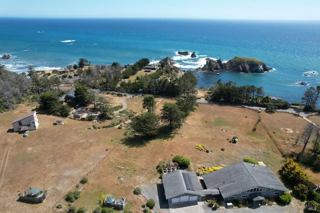 a kitchen with stainless steel appliances granite countertop a sink refrigerator and cabinets
