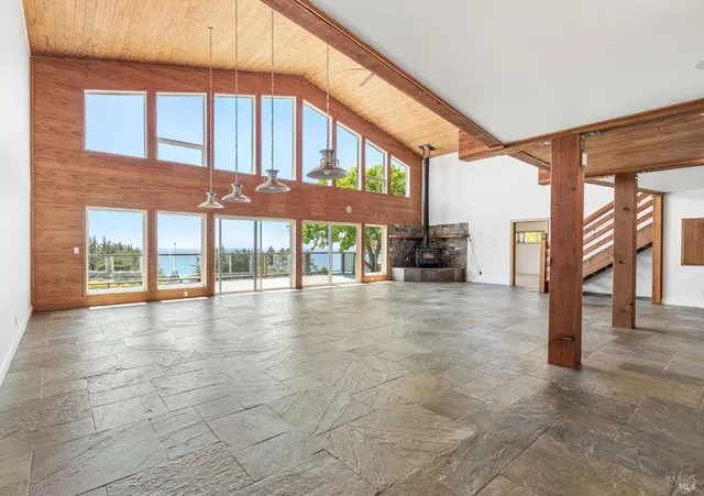 an empty room with windows and closet