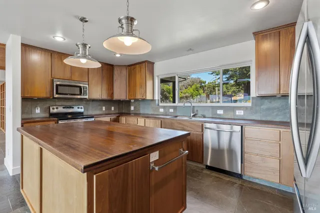 an empty room with a ceiling fan and window