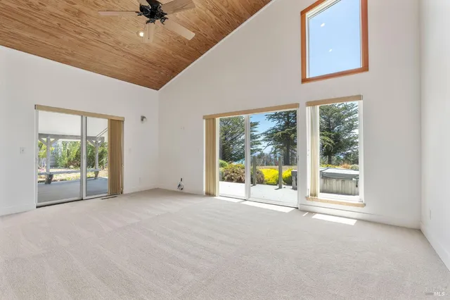 a view of room with window and a ceiling fan