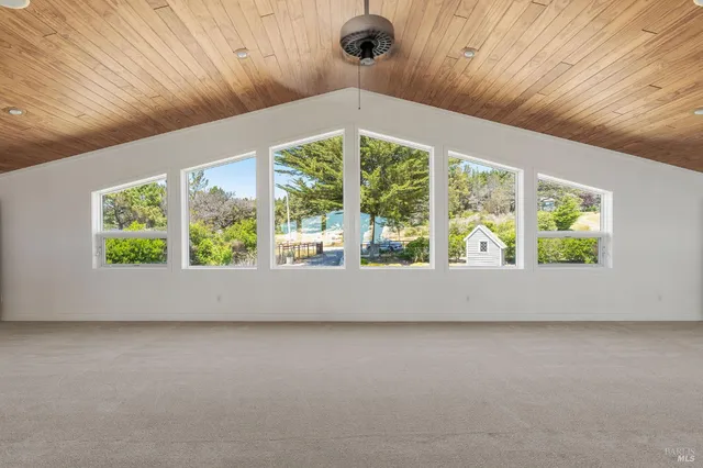 a bed room with a bed and a large window