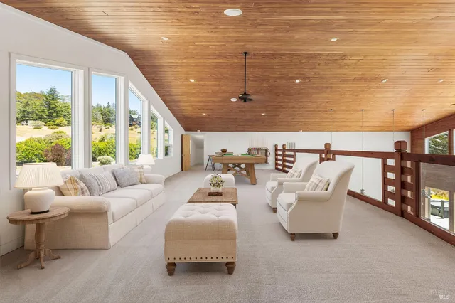 a view of outdoor space with wooden floor and windows