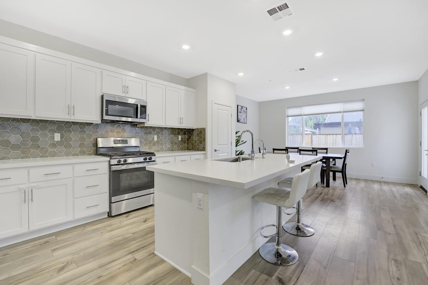 5161 Maniago Way Antioch, CA 94531 - Photo 12 of 42 a kitchen with stainless steel appliances sink stove refrigerator and cabinets