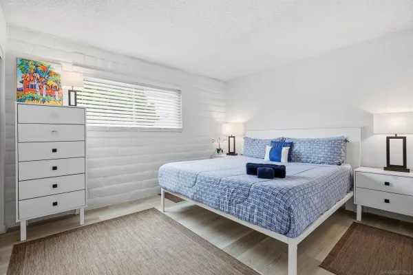 a bedroom with a bed and dresser