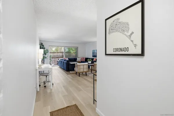 a living room with furniture and a painting on the wall