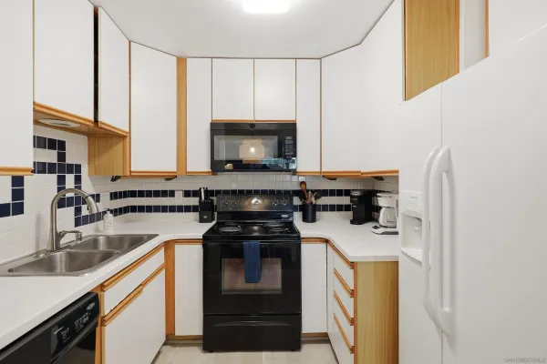 a kitchen with a sink a stove and cabinets