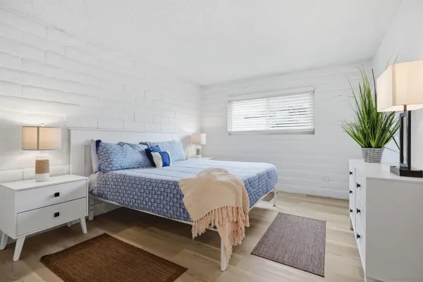 a bedroom with a bed and window