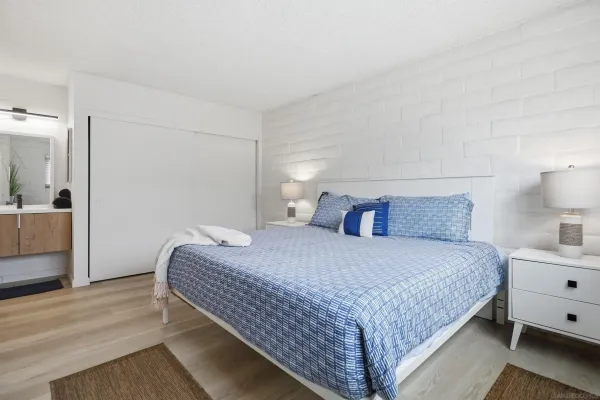 a bedroom with a bed and a night stand