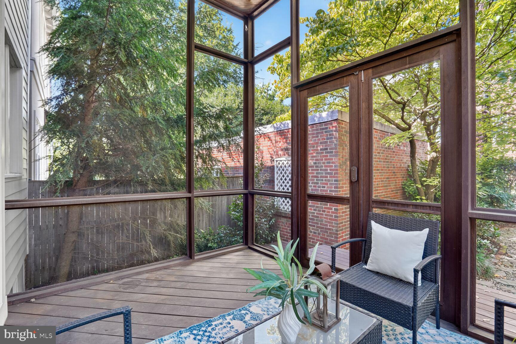 4302 37th Street Northwest Washington, DC 20008 - Photo 19 of 39 Serene screened porch with lush greenery.