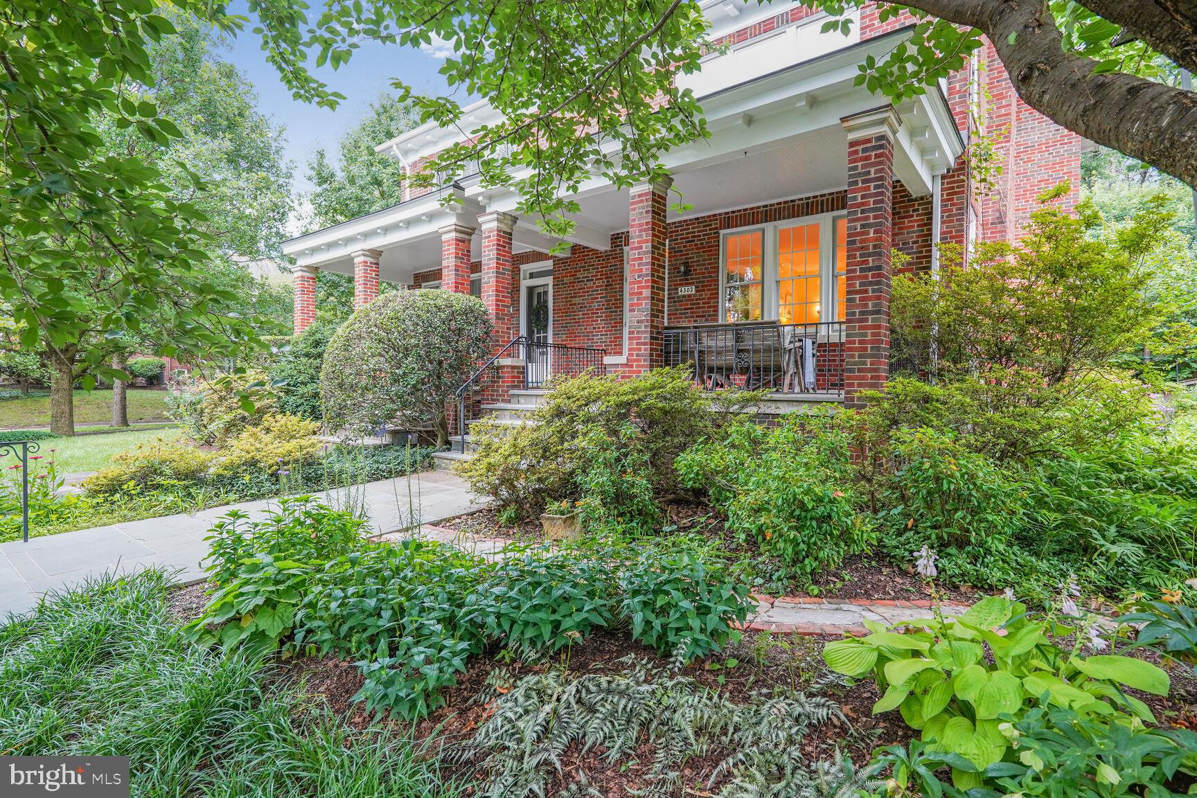 4302 37th Street Northwest Washington, DC 20008 - Photo 2 of 39 Charming brick home with lush greenery.