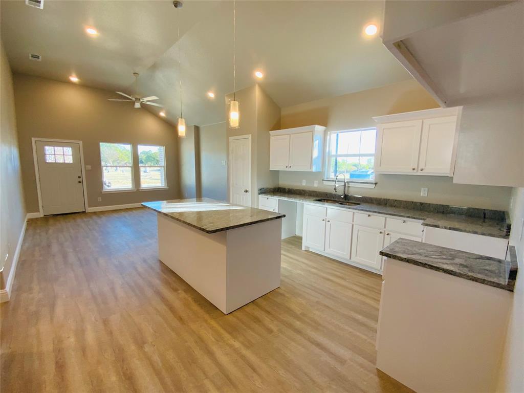 2306 Church Street Greenville, TX 75401 - Photo 1 of 1 a large kitchen with stainless steel appliances a large counter top a sink and a dishwasher