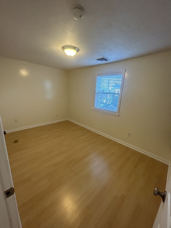 36 Hunting Street, Unit 2 Cambridge, MA 02141 - Photo 11 of 19 an empty room with a empty space and windows