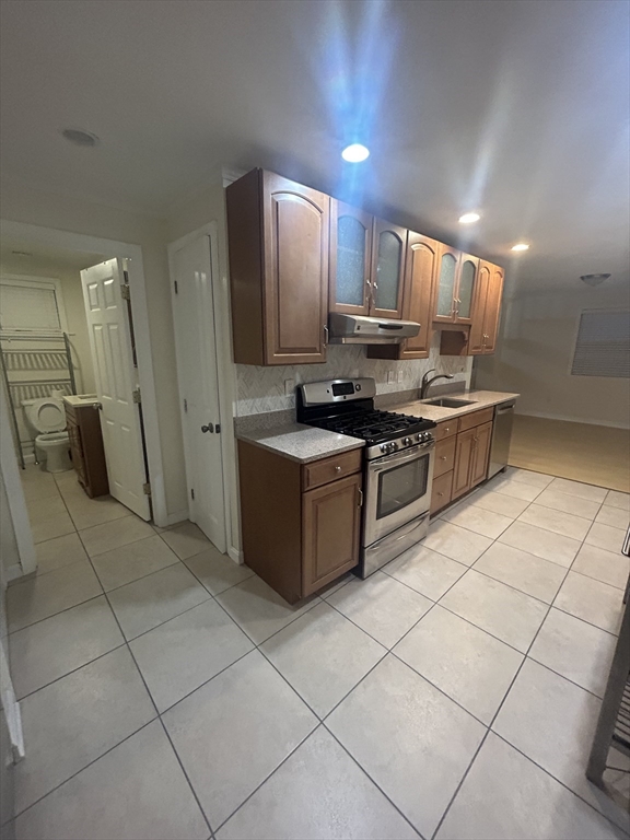 36 Hunting Street, Unit 2 Cambridge, MA 02141 - Photo 3 of 19 a kitchen with stainless steel appliances granite countertop a stove a sink and a refrigerator