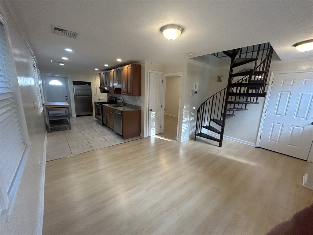36 Hunting Street, Unit 2 Cambridge, MA 02141 - Photo 4 of 19 a view of a hallway with stairs