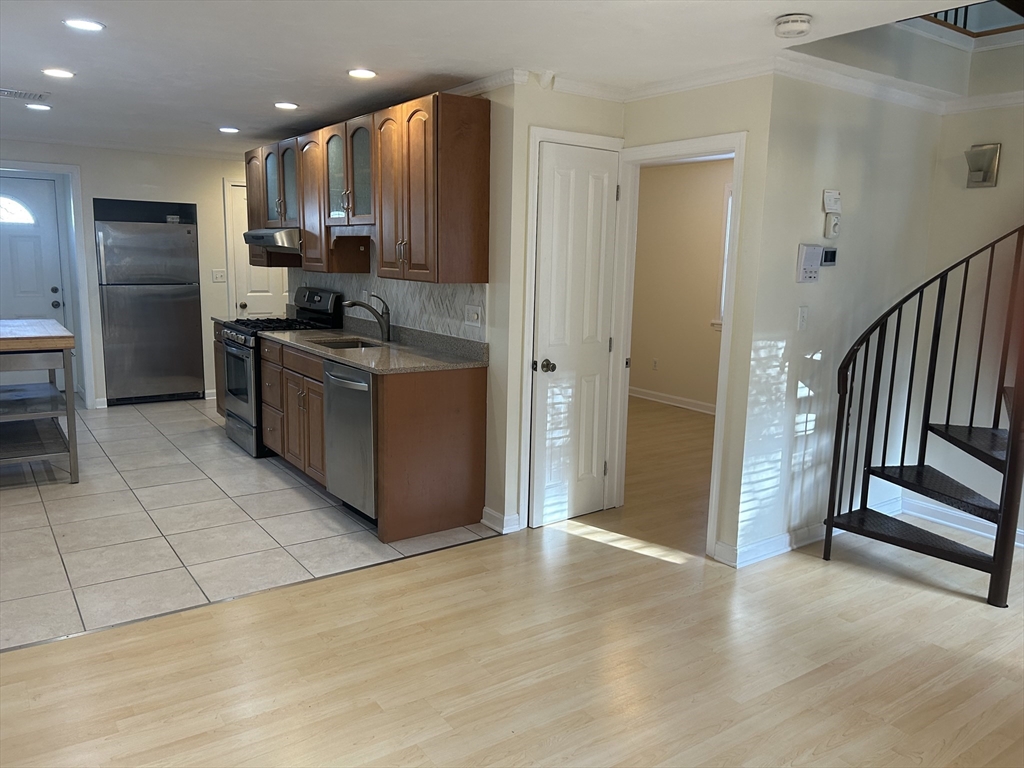 36 Hunting Street, Unit 2 Cambridge, MA 02141 - Photo 6 of 19 a kitchen with stainless steel appliances granite countertop a refrigerator and a sink