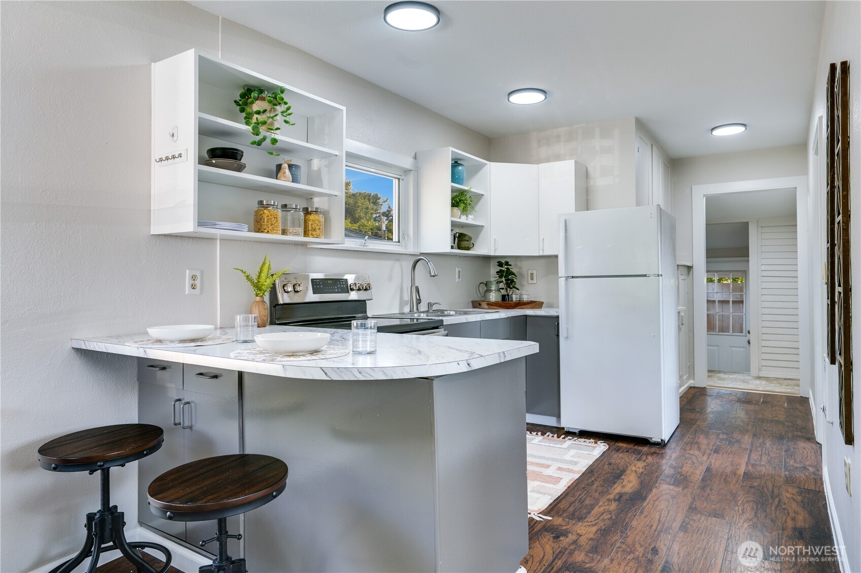 911 Hunt Avenue Sumner, WA 98390 - Photo 6 of 29 a kitchen with stainless steel appliances granite countertop a sink a refrigerator and a stove