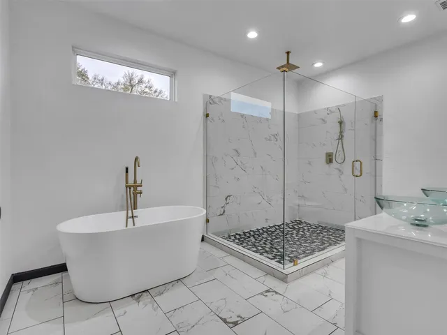 a view of an empty room with bathroom and mirror