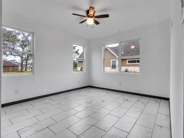 a view of a house with yard and deck