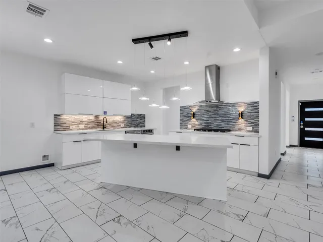 a kitchen with stainless steel appliances kitchen island granite countertop a sink and cabinets