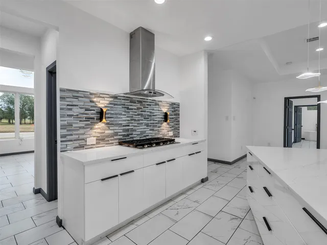 a kitchen with granite countertop white cabinets and white appliances