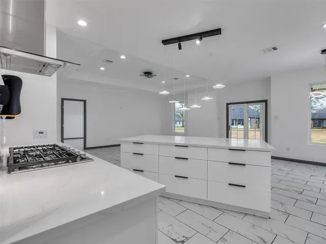 a kitchen with cabinets and window
