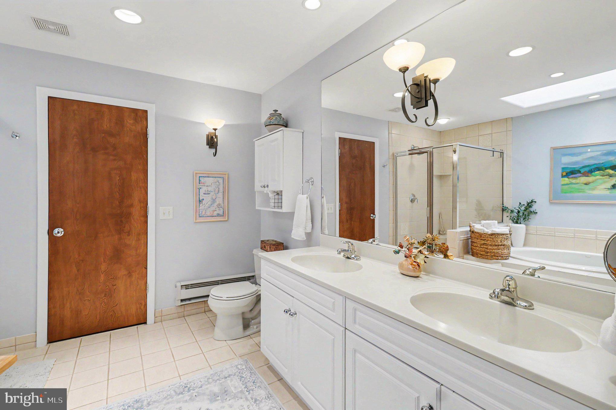 25 East Knowlton Road Media, PA 19063 - Photo 37 of 73 a bathroom with a double vanity sink mirror and toilet