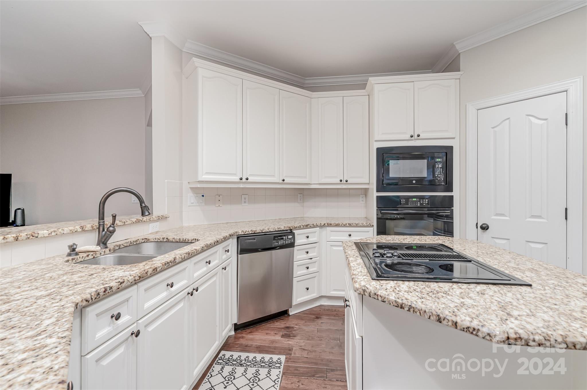3410 Rhett Butler Place Charlotte, NC 28270 - Photo 8 of 31 a kitchen with granite countertop a sink stove and cabinets