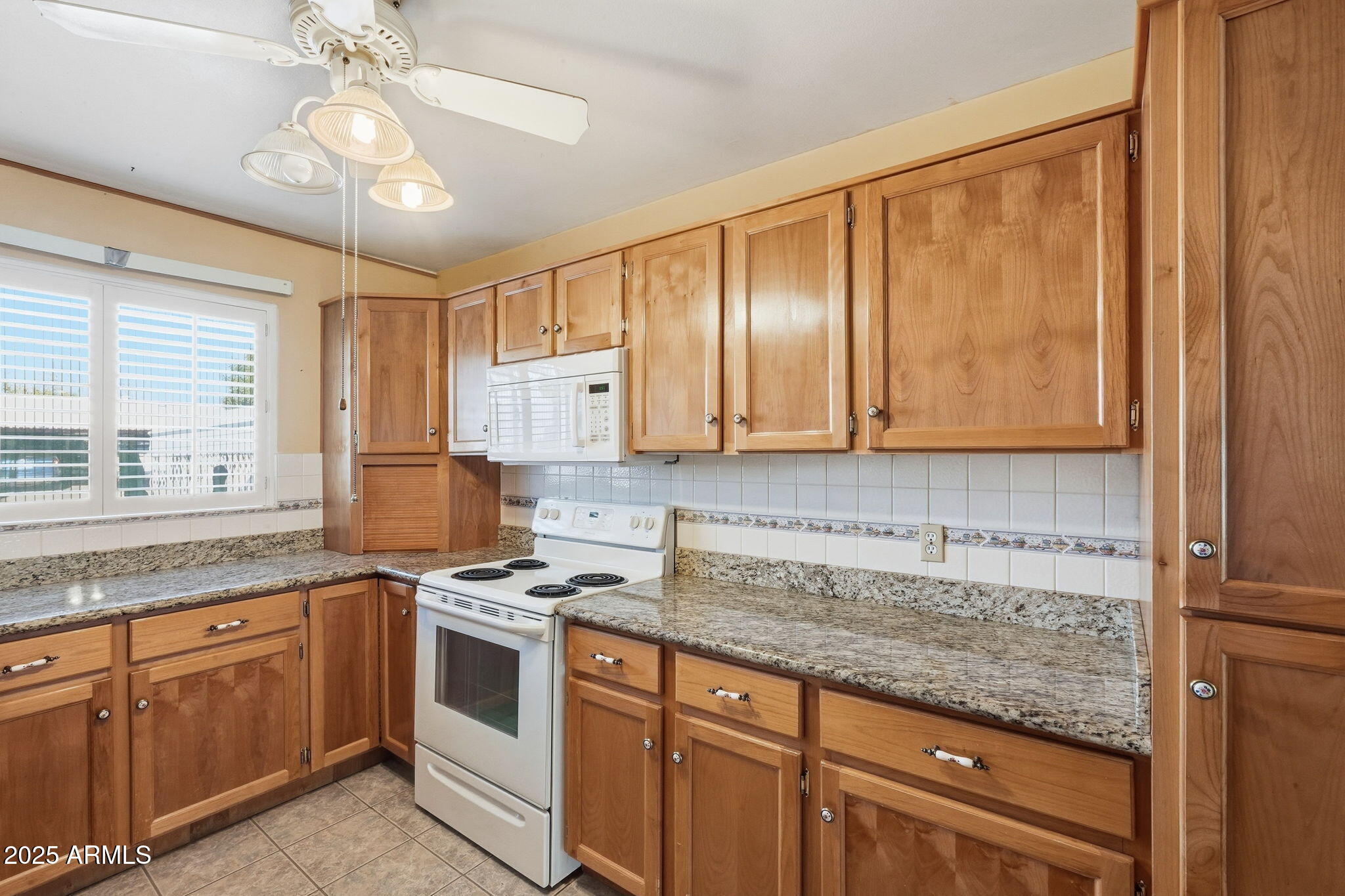 1208 North Palm Ln Circle Coolidge, AZ 85128 - Photo 15 of 33 a kitchen with granite countertop a sink stainless steel appliances and cabinets