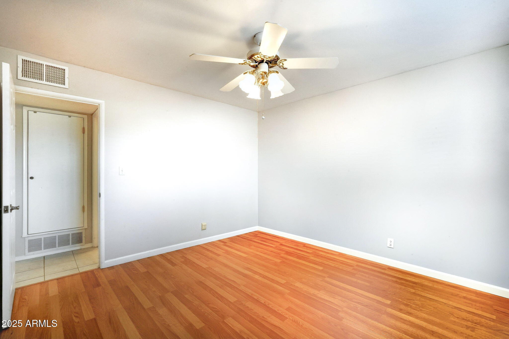 1208 North Palm Ln Circle Coolidge, AZ 85128 - Photo 23 of 33 a view of a big room with wooden floor and chandelier fan