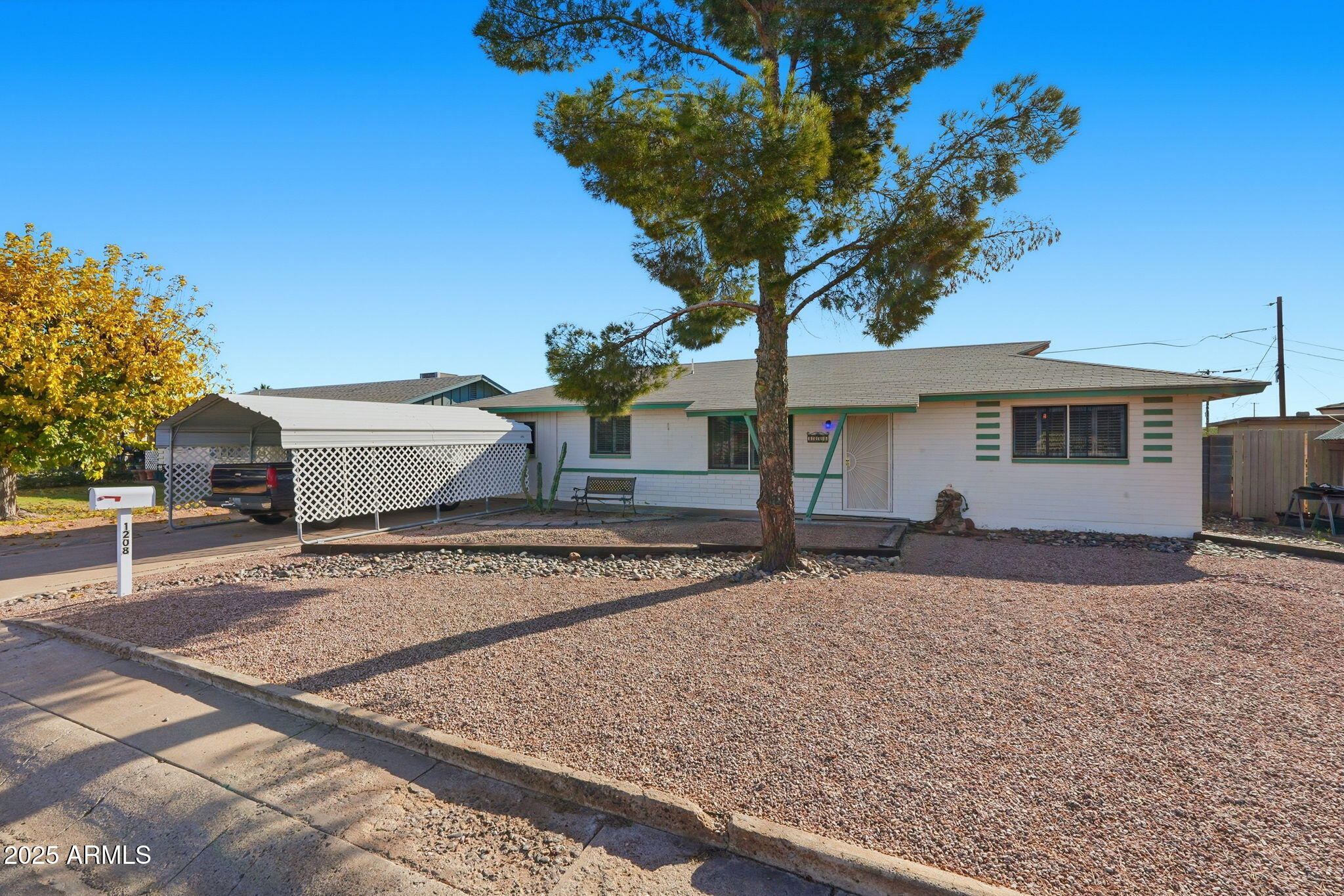 1208 North Palm Ln Circle Coolidge, AZ 85128 - Photo 3 of 33 a front view of a house with a yard and garage