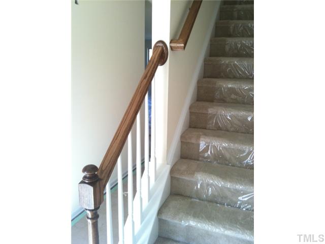 6527 Horseback Lane Raleigh, NC 27610 - Photo 10 of 16 Open handrails and hardwoods in foyer