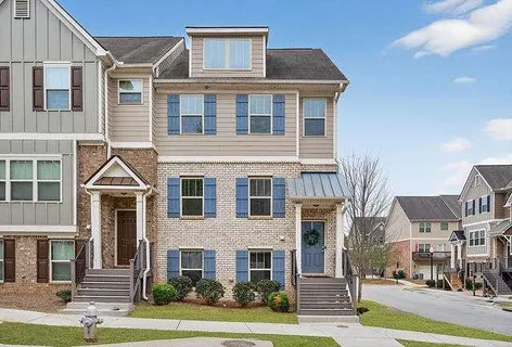a front view of a residential apartment building with a yard