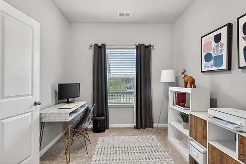 a workspace with furniture and window