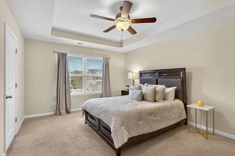 a bedroom with a bed and window