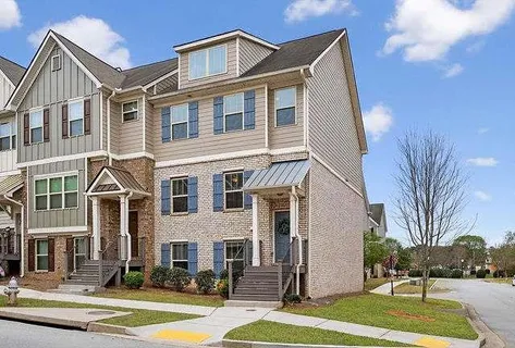 a front view of a residential apartment building with a yard