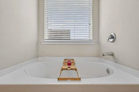 a bathroom with a bathtub and shower